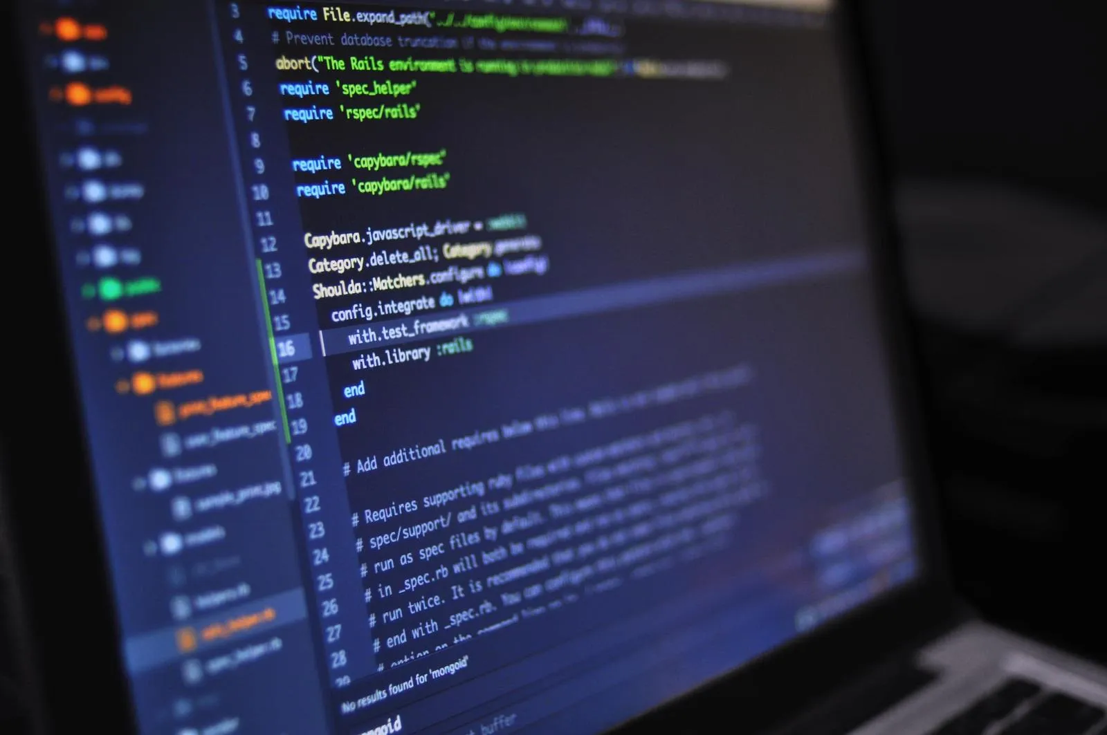 Developer reviewing code on screen while managing cloud resources